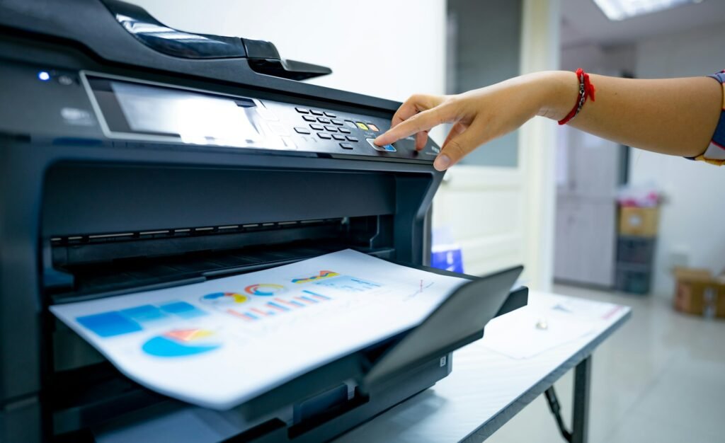 Office worker prints paper on multifunction laser printer. Copy, print, scan, and fax machine